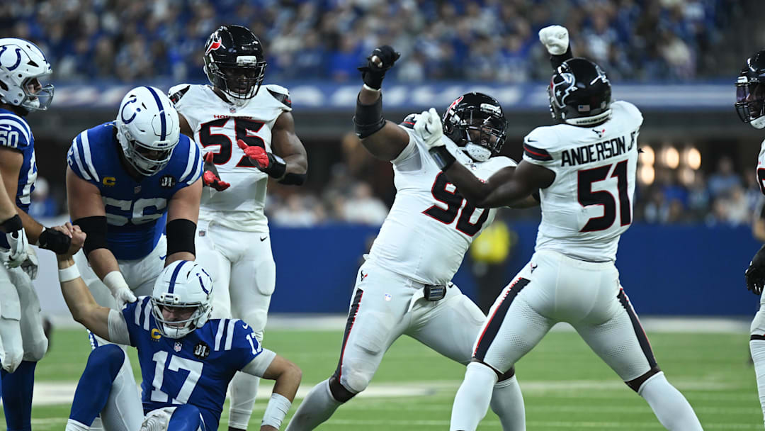 Nov 30, 2025; Indianapolis, Indiana, USA; Houston Texans defensive tackle Sheldon Rankins (90) and Houston Texans defensive end Will Anderson Jr. (51) celebrate after sacking Indianapolis Colts quarterback Daniel Jones (17) during the first half at Lucas Oil Stadium. Mandatory Credit: Robert Goddin-Imagn Images