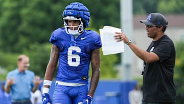 Kentucky offensive coordinator Bush Hamdan talks with wide receiver Dane Key during practice Friday. August 2, 2024 in Lexington.