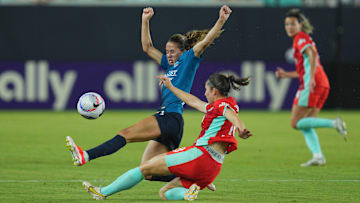 Chicago Red Stars midfielder Shea Groom (10) battles Kansas City Current defender Isabel Rodriguez (18) for the ball in the second half at CPKC Stadium 