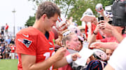 Aug 6, 2025; Foxborough, MA, USA; New England Patriots quarterback Drake Maye (10) signs an autograph for a fan after training camp at Gillette Stadium. Mandatory Credit: Eric Canha-Imagn Images