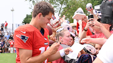 Aug 6, 2025; Foxborough, MA, USA; New England Patriots quarterback Drake Maye (10) signs an autograph for a fan after training camp at Gillette Stadium. Mandatory Credit: Eric Canha-Imagn Images