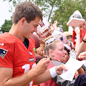 Aug 6, 2025; Foxborough, MA, USA; New England Patriots quarterback Drake Maye (10) signs an autograph for a fan after training camp at Gillette Stadium. Mandatory Credit: Eric Canha-Imagn Images