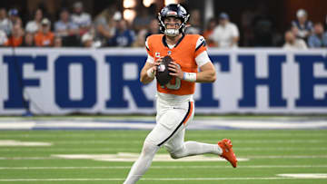 Sep 14, 2025; Indianapolis, Indiana, USA;  Denver Broncos quarterback Bo Nix (10) runs with the ball during the fourth quarter against the Indianapolis Colts at Lucas Oil Stadium. Mandatory Credit: Robert Goddin-Imagn Images