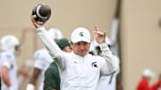 Oct 18, 2025; Bloomington, Indiana, USA; Michigan State Spartans head coach Jonathan Smith throws the football prior to the game against the Indiana Hoosiers at Memorial Stadium. Mandatory Credit: Robert Goddin-Imagn Images