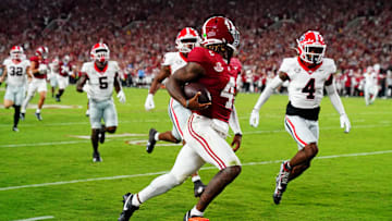 Sep 28, 2024; Tuscaloosa, Alabama, USA; Alabama Crimson Tide quarterback Jalen Milroe (4) scores a touchdown during the second quarter against the Georgia Bulldogs at Bryant-Denny Stadium. Mandatory Credit: John David Mercer-Imagn Images