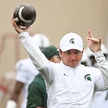 Oct 18, 2025; Bloomington, Indiana, USA; Michigan State Spartans head coach Jonathan Smith throws the football prior to the game against the Indiana Hoosiers at Memorial Stadium. Mandatory Credit: Robert Goddin-Imagn Images