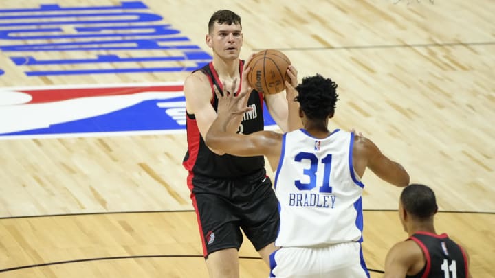 Jul 15, 2024; Las Vegas, NV, USA; Portland Trail Blazers center Donovan Clingan (23) shoots the ball against Philadelphia 76ers center Tony Bradley (31) during the first half at Thomas & Mack Center. Mandatory Credit: Lucas Peltier-USA TODAY Sports