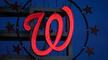 The Curly W, surrounded by 3 Stars on either side.