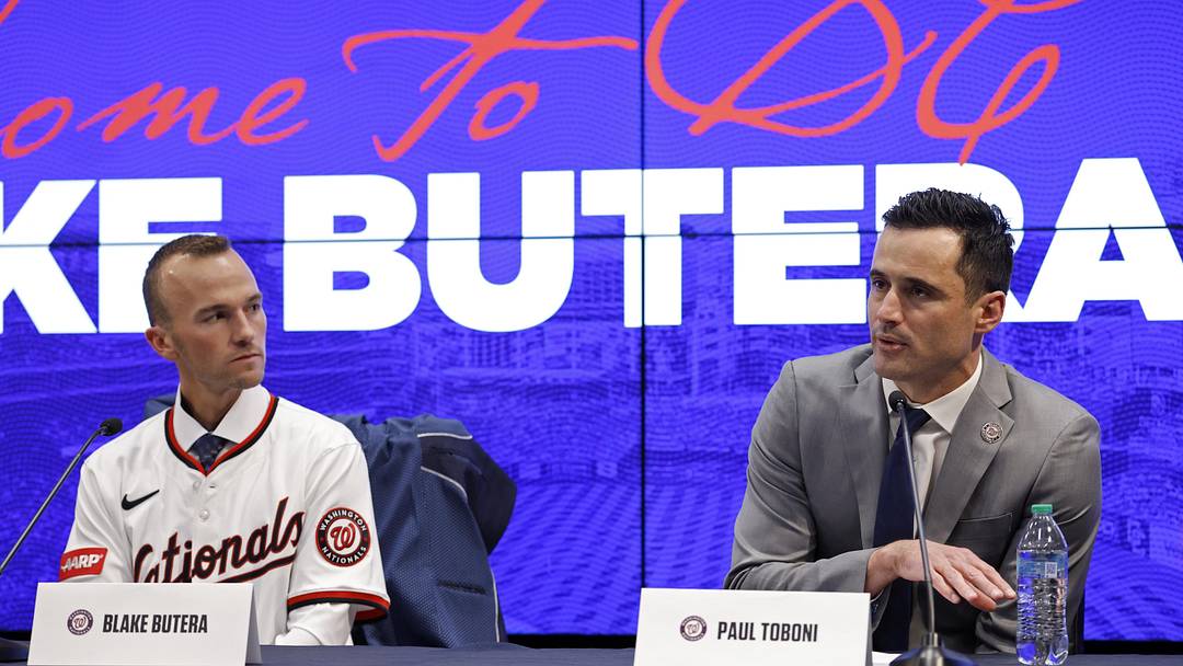 Nov 17, 2025; Washington, District of Columbia, USA; New Washington Nationals manager Blake Butera (L) listens at his introductory press conference as Nationals general manager and president of baseball operations Paul Toboni (R) speaks at Nationals Park. Mandatory Credit: Geoff Burke-Imagn Images