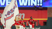 Atlanta Braves mascot Blooper and left fielder Ramon Laureano and center fielder Michael Harris II celebrate after a victory over the Los Angeles Dodgers at Truist Park. 