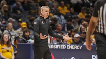 Dec 9, 2025; Morgantown, West Virginia, USA; West Virginia Mountaineers head coach Ross Hodge talks to a player during the second half against the Little Rock Trojans at Hope Coliseum. Mandatory Credit: Ben Queen-Imagn Images