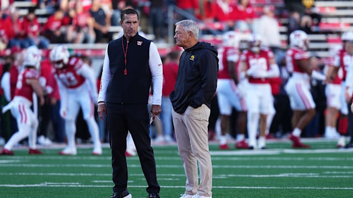 Oct 11, 2025; Madison, Wisconsin, USA; Wisconsin Badgers head coach Luke Fickell and Iowa Hawkeyes head coach Kirk Ferentz meet at mid field before the game at Camp Randall Stadium. Mandatory Credit: Ross Harried-Imagn Images