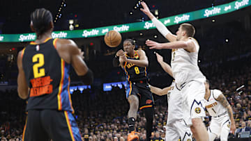 May 7, 2025; Oklahoma City, Oklahoma, USA; Oklahoma City Thunder forward Jalen Williams (8) passes to guard Shai Gilgeous-Alexander (2) as Denver Nuggets center Nikola Jokic (15) defends in the second half during game two of the second round for the 2025 NBA Playoffs at Paycom Center. Mandatory Credit: Alonzo Adams-Imagn Images