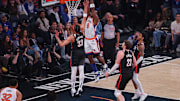 Mar 30, 2025; New York, New York, USA; New York Knicks forward OG Anunoby (8) goes up for a dunk during the first half in front of Portland Trail Blazers center Donovan Clingan (23) and forward Toumani Camara (33) at Madison Square Garden. Mandatory Credit: Vincent Carchietta-Imagn Images