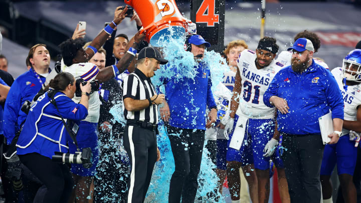 Dec 26, 2023; Phoenix, AZ, USA; Kansas Jayhawks head coach Lance Leipold has Gatorade dumped on him in the closing seconds of the game against the UNLV Rebels in the Guaranteed Rate Bowl at Chase Field. Mandatory Credit: Mark J. Rebilas-USA TODAY Sports