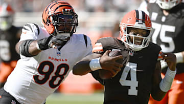 Oct 20, 2024; Cleveland, Ohio, USA; Cincinnati Bengals defensive tackle Sheldon Rankins (98) tackles Cleveland Browns quarterback Deshaun Watson (4) during the first half at Huntington Bank Field. Mandatory Credit: Ken Blaze-Imagn Images