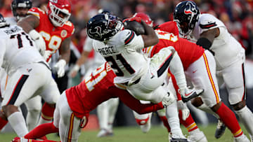 Dameon Pierce carries the ball in a Houston Texans playoff game versus the Kansas City Chiefs