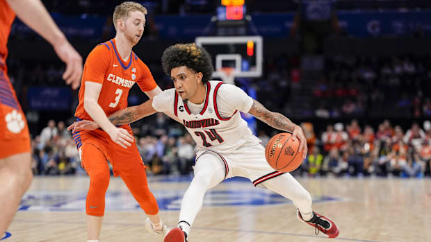 Louisville guard Chucky Hepburn goes to the basket against Clemson guard Jake Heidbreder.