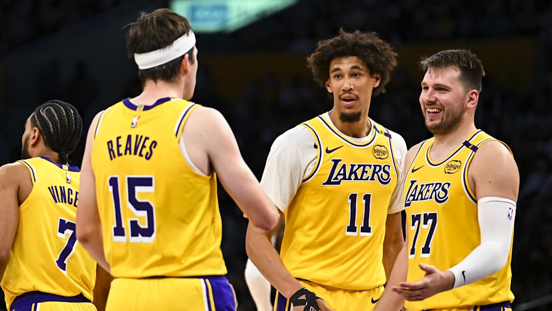 Apr 11, 2025; Los Angeles, California, USA; Los Angeles Lakers guard Luka Dončić (77) celebrates with center Jaxson Hayes (11), and guard Austin Reaves (15) after scoring against the Houston Rockets during the first half at Crypto.com Arena.