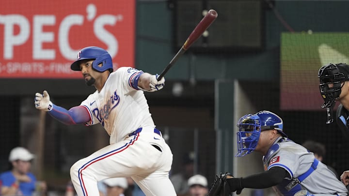 Jun 17, 2025; Arlington, Texas, USA; Texas Rangers second baseman Marcus Semien (2) follows through on a single against the Kansas City Royals during the eighth inning at Globe Life Field. 