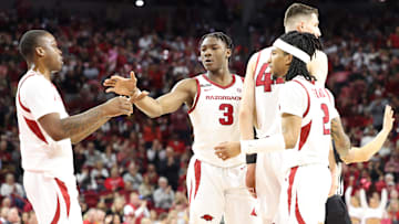 Jan 8, 2025; Fayetteville, Arkansas, USA; Arkansas Razorbacks forward Adou Thiero (3) celebrates after a play with guards Johnell Davis (1) and Boogie Fland (2) during the second half against the Ole Miss Rebels at Bud Walton Arena. Ole Miss won 73-66. Mandatory Credit: Nelson Chenault-Imagn Images