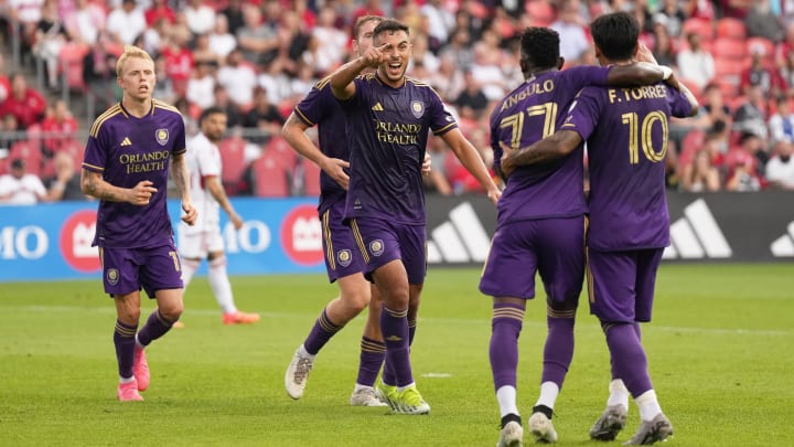  Jul 3, 2024; Toronto, Ontario, CAN; Orlando City midfielder Martin Ojeda (11) scores a goal and celebrates with midfielder Ivan Angulo (77)  against Toronto FC during the first half at BMO Field. Mandatory Credit: Nick Turchiaro-USA TODAY Sports