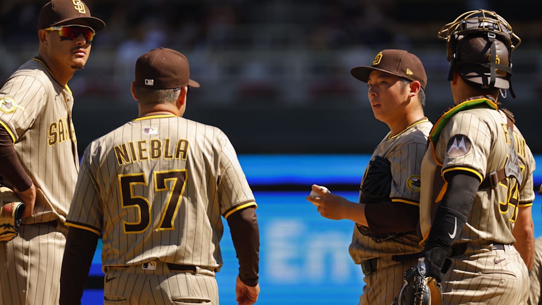 Aug 31, 2025; Minneapolis, Minnesota, USA; San Diego Padres relief pitcher Yuki Matsui (1) awaits pitching coach Ruben Niebla in the seventh inning of the game with the Minnesota Twins at Target Field. Mandatory Credit: Bruce Kluckhohn-Imagn Images