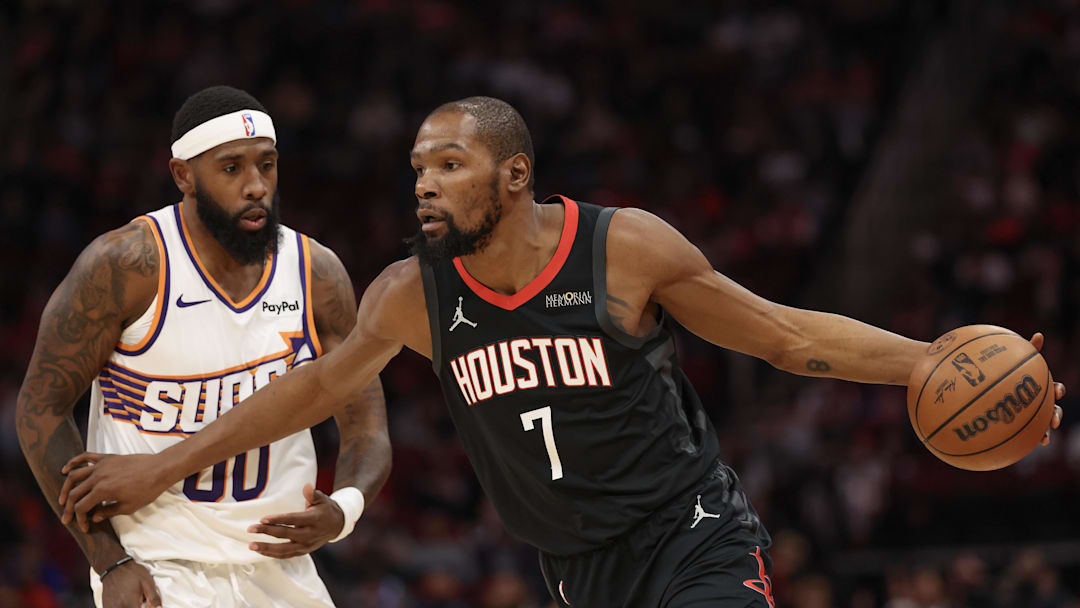 Jan 5, 2026; Houston, Texas, USA; Houston Rockets forward Kevin Durant (7) dribbles against Phoenix Suns forward Royce O'Neale (00) in the first quarter at Toyota Center. Mandatory Credit: Thomas Shea-Imagn Images