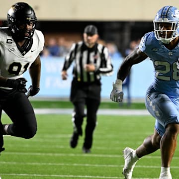 North Carolina Tar Heels running back Omarion Hampton runs as Wake Forest Demon Deacons defensive lineman Kevin Pointer defends in the third quarter at Kenan Memorial Stadium.