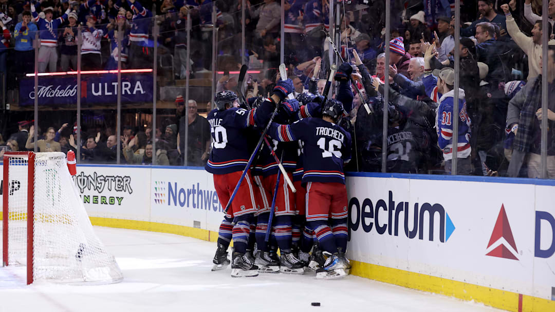 Jan 9, 2025; New York, New York, USA; New York Rangers players celebrate after defeating the New Jersey Devils in overtime at Madison Square Garden. Mandatory Credit: Brad Penner-Imagn Images