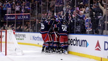 Jan 9, 2025; New York, New York, USA; New York Rangers players celebrate after defeating the New Jersey Devils in overtime at Madison Square Garden. Mandatory Credit: Brad Penner-Imagn Images