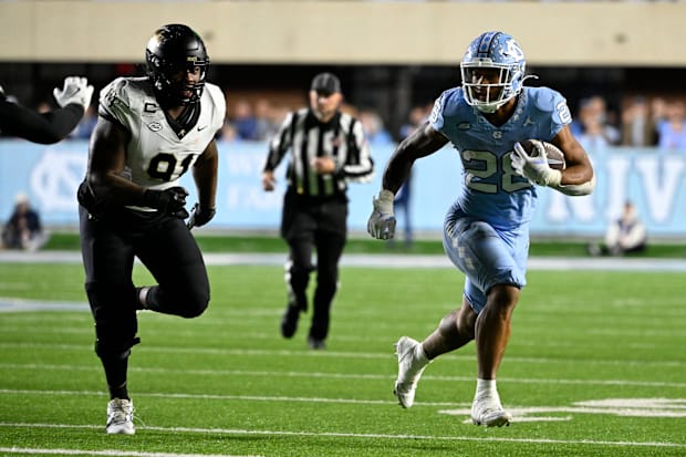 North Carolina Tar Heels running back Omarion Hampton runs as Wake Forest Demon Deacons defensive lineman Kevin Pointer