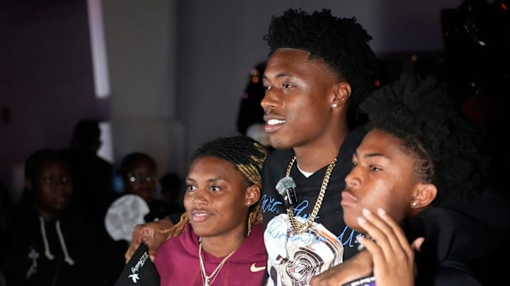 Friends and family pose for photos with Booker High defensive end/wide receiver Chauncey Kennon after Kennon announced he has selected Florida State University to commit to during a party Sunday afternoon, July 6, 2025 at the DeSoto Boys and Girls Club in Bradenton.