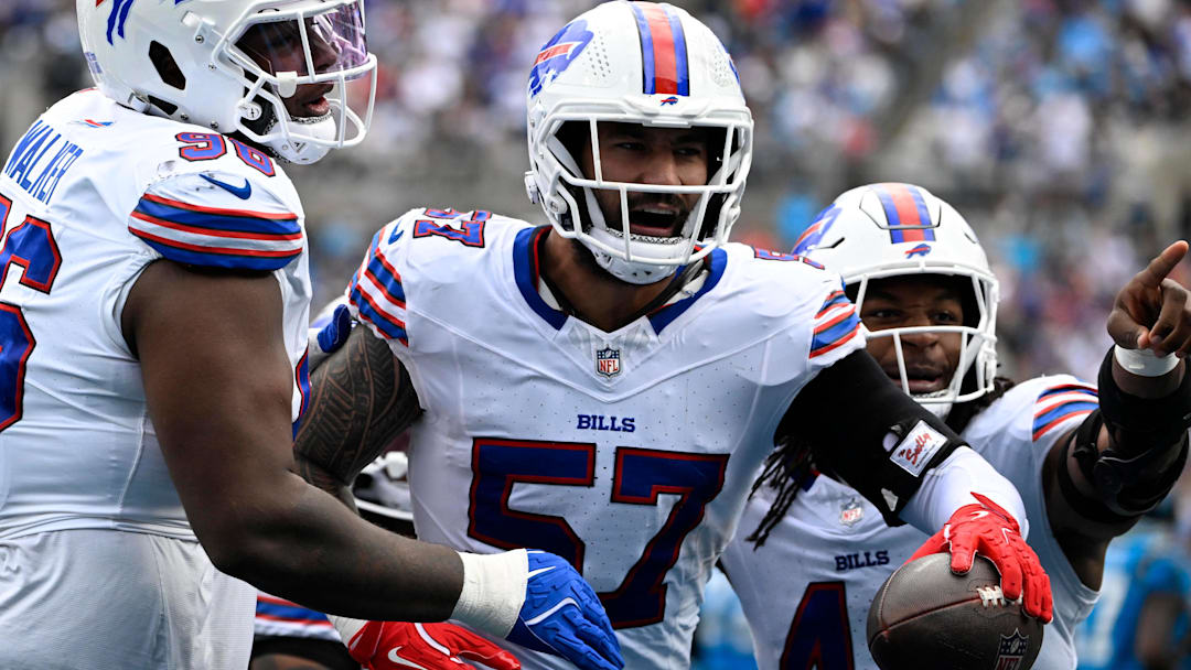 Oct 26, 2025; Charlotte, North Carolina, USA;  Buffalo Bills defensive end AJ Epenesa (57) celebrates with guard Connor McGovern (66) and linebacker Dorian Williams (42)  after intercepting a pass in the second quarter against the Carolina Panthers at Bank of America Stadium.