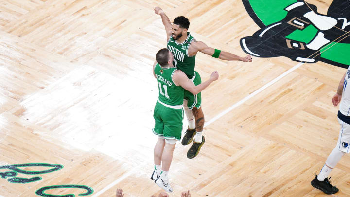 Boston Celtics guard Payton Pritchard (11) celebrates with forward Jayson Tatum (0) after a three-point shot in the second quarter.