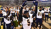 Sep 14, 2024; Starkville, Mississippi, USA; Toledo Rockets players react after defeating the Mississippi State Bulldogs at Davis Wade Stadium at Scott Field. Mandatory Credit: Matt Bush-Imagn Images