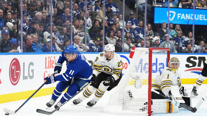 Apr 27, 2024; Toronto, Ontario, CAN; Toronto Maple Leafs center Max Domi (11) battles for the puck with Boston Bruins defenseman Parker Wotherspoon (29) behind goaltender Jeremy Swayman (1) during the third period in game four of the first round of the 2024 Stanley Cup Playoffs at Scotiabank Arena. Mandatory Credit: Nick Turchiaro-USA TODAY 