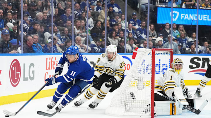 Apr 27, 2024; Toronto, Ontario, CAN; Toronto Maple Leafs center Max Domi (11) battles for the puck with Boston Bruins defenseman Parker Wotherspoon (29) behind goaltender Jeremy Swayman (1) during the third period in game four of the first round of the 2024 Stanley Cup Playoffs at Scotiabank Arena. Mandatory Credit: Nick Turchiaro-USA TODAY 