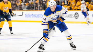 Feb 8, 2025; Nashville, Tennessee, USA;  Buffalo Sabres center Dylan Cozens (24) takes a shot on goal during the second period at Bridgestone Arena. Mandatory Credit: Steve Roberts-Imagn Images
