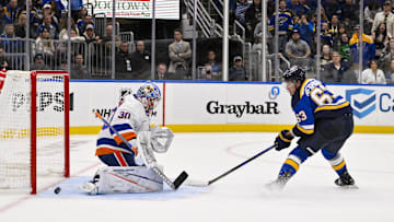 Oct 17, 2024; St. Louis, Missouri, USA;  St. Louis Blues left wing Jake Neighbours (63) scores the game winning goal against New York Islanders goaltender Ilya Sorokin (30) in overtime at Enterprise Center. Mandatory Credit: Jeff Curry-Imagn Images