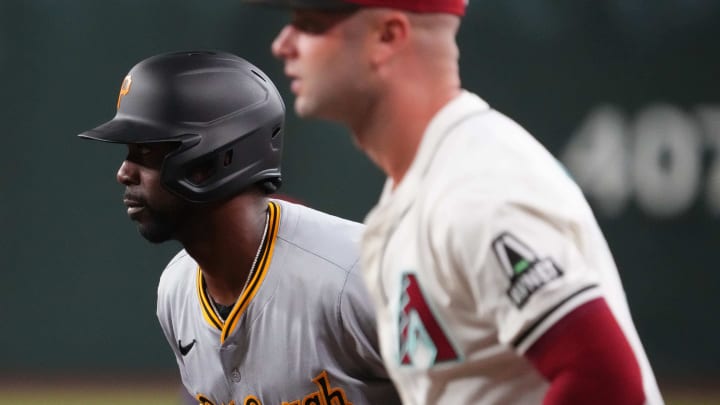 Jul 26, 2024; Phoenix, Arizona, USA; Pittsburgh Pirates outfielder Andrew McCutchen (22) leads off first base as Arizona Diamondbacks first base Christian Walker (53) covers the bag during the first inning at Chase Field.