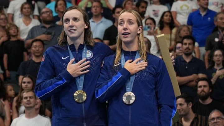 Katie Ledecky (left) and Paige Madden (right) on the podium after winning medals in the women's 800m freestyle at the 2024 Paris Olympics on Saturday, August 3. 