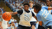 Oct 4, 2025; Charlotte, NC, USA; North Carolina Tar Heels guard Jaydon Young (4) and guard Evan Smith (32) fight for the ball in the second half at Dean E. Smith Center. 