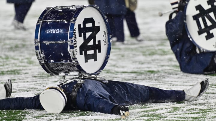 Nov 19, 2022; South Bend, Indiana, USA; Members of the Notre Dame Marching Band make snow angels following the game between the Notre Dame Fighting Irish and the Boston College Eagles at Notre Dame Stadium.