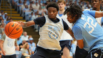 Oct 4, 2025; Charlotte, NC, USA; North Carolina Tar Heels guard Jaydon Young (4) and guard Evan Smith (32) fight for the ball in the second half at Dean E. Smith Center. Mandatory Credit: Bob Donnan-Imagn Images