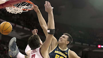 Dec 3, 2024; Madison, Wisconsin, USA; Michigan center Vladislav Goldin (50) dunks on Wisconsin forward Carter Gilmore (7) during the first half of their game Tuesday, December 3, 2024 at the Kohl Center in Madison, Wisconsin. Mandatory Credit: Mark Hoffman/USA TODAY Network via Imagn Images 