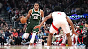 Jan 6, 2025; Toronto, Ontario, CAN; Milwaukee Bucks forward Giannis Antetokounmpo (34) dribbles the ball as Toronto Raptors forward Scottie Barnes (4) defends during the second quarter at Scotiabank Arena. Mandatory Credit: Nick Turchiaro-Imagn Images