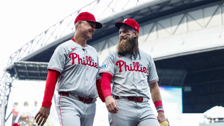 Aug 3, 2024; Seattle, Washington, USA; Philadelphia Phillies third base coach Dusty Wathan (62, left) walks to the dugout with center fielder Brandon Marsh (16, right) before the first inning against the Seattle Mariners at T-Mobile Park. Mandatory Credit: Joe Nicholson-USA TODAY Sports