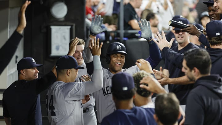 Aug 13, 2024; Chicago, Illinois, USA; New York Yankees outfielder Juan Soto (22) celebrates with teammates in the dugout after hitting a solo home run against the Chicago White Sox during the fifth inning at Guaranteed Rate Field. Mandatory Credit: Kamil Krzaczynski-USA TODAY Sports