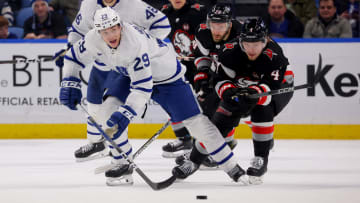 Mar 30, 2024; Buffalo, New York, USA;  Toronto Maple Leafs right wing Pontus Holmberg (29) and Buffalo Sabres defenseman Bowen Byram (4) go after a loose puck during the third period at KeyBank Center. Mandatory Credit: Timothy T. Ludwig-USA TODAY Sports